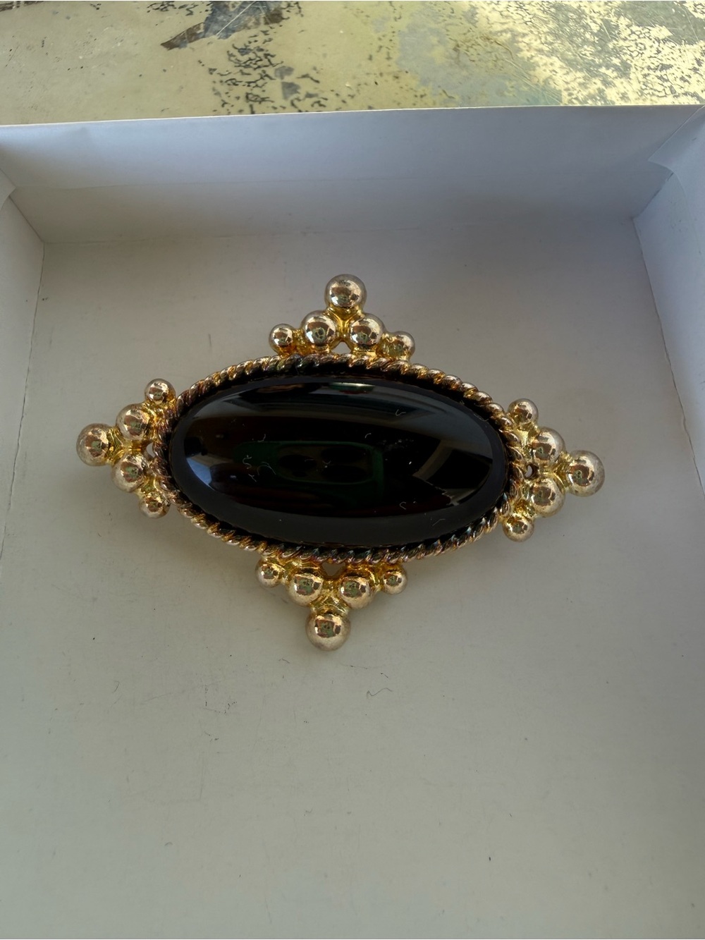 Gold-Tone Brooch with Black Oval Stone